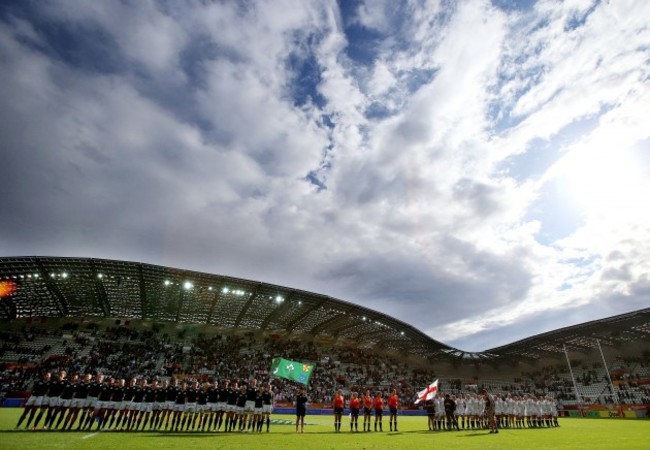 The two teams stand for the National Anthems