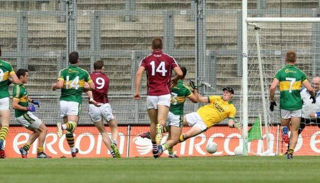 Thomas Flynn scores his side's opening goal past goalkeeper Brian Kelly