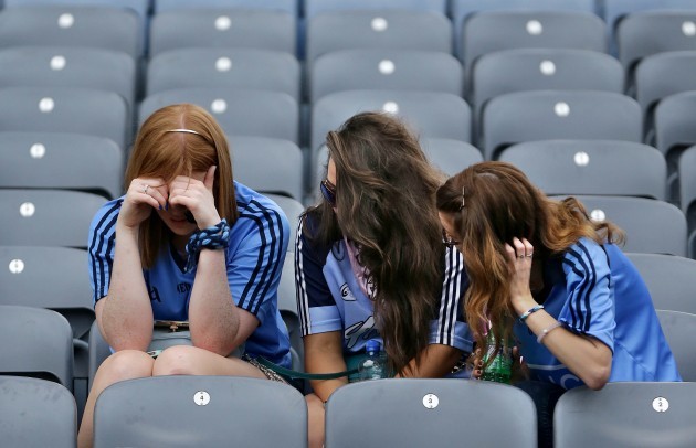Dejected Dublin fans console each other after the game