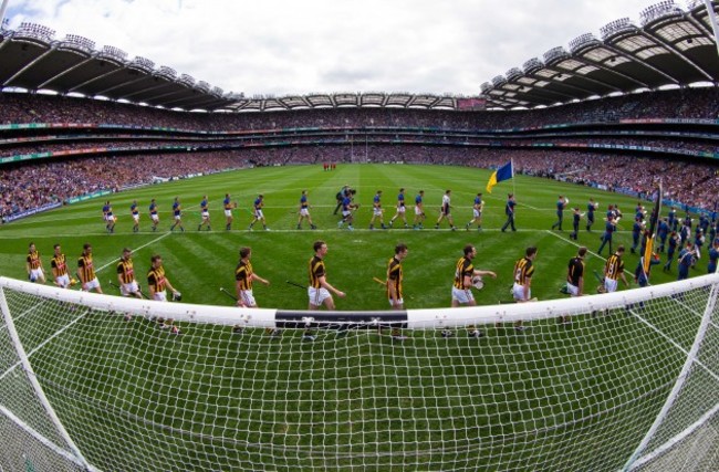 Kilkenny and Tipperary players walk behind the band