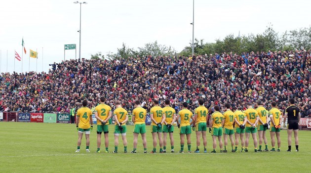 Donegal players observe the minutes silence prior to throw in