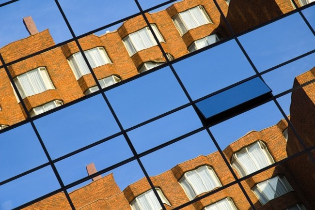 20093557 IRELAND Dublin Dublin Modern apartment block reflected in windows of office block