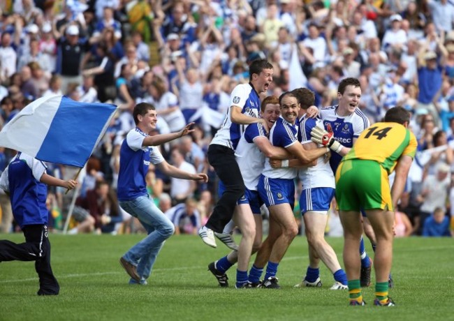 Monaghan players are mobbed by ecstatic supporters after the game