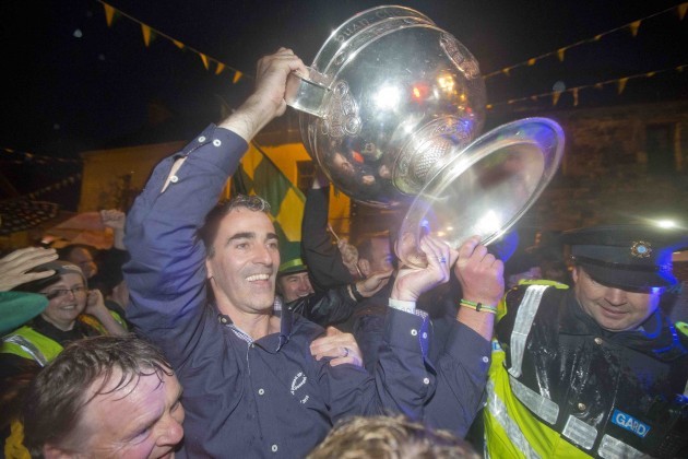 Jim McGuinness and Michael Murphy carry the Sam Maguire across the Termon river from Fermanagh into Donegal