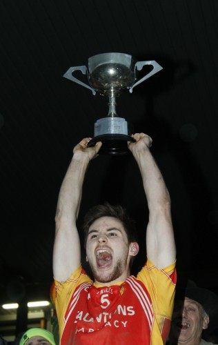 Donal Newcombe lifts the cup