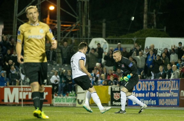 Dundalk goalkeeper Peter Cherrie celebrates with Andy Boyle after Shamrock Rovers' Ryan Brennan misses a penalty
