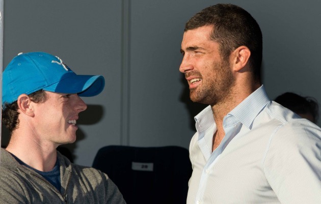 Rory McIlroy chats with the injured Rob Kearney before the game