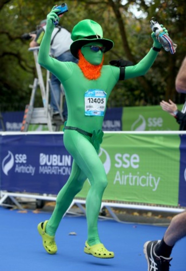 A runner in costume crosses the finish line