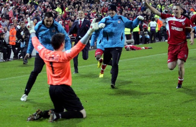 Ciaran Kelly is mobbed by teammates after saving the final penalty