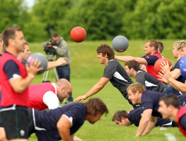 The squad warm up with medicine balls