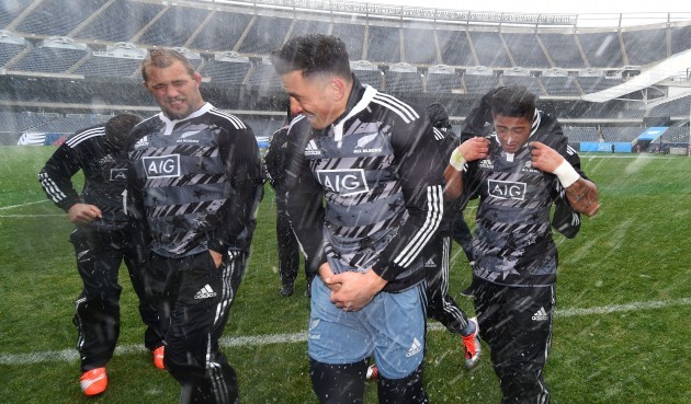 Owen Franks, Sonny Bill Williams and Augustine Pulu shelter from the wind and snow
