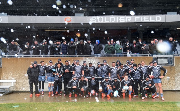 The All Blacks pose for a team photo despite the wind and rain