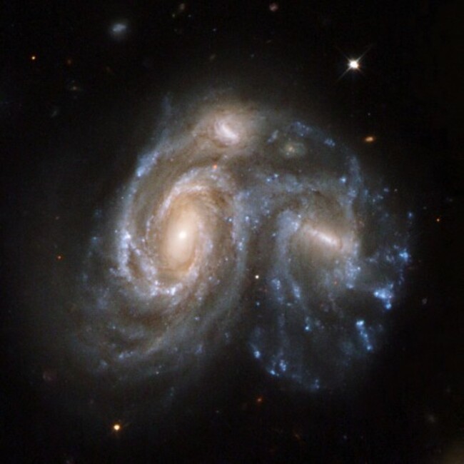 this-spectacular-snapshot-in-time-shows-two-galaxies-in-the-process-of-merging-together-it-is-part-of-a-series-of-59-images-released-in-2008-showing-different-stages-of-galaxy-merging-before-during-and-after-this-