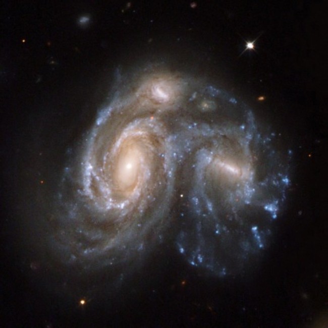 this-spectacular-snapshot-in-time-shows-two-galaxies-in-the-process-of-merging-together-it-is-part-of-a-series-of-59-images-released-in-2008-showing-different-stages-of-galaxy-merging-before-during-and-after-this-