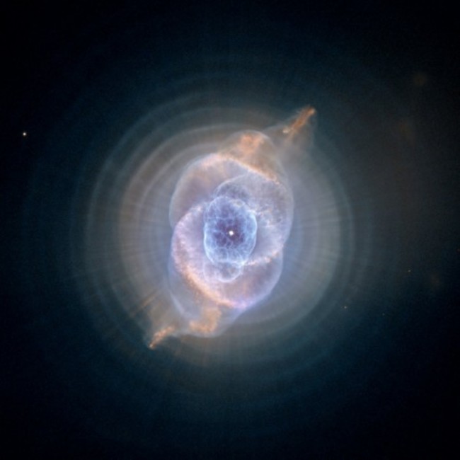 the-star-at-the-center-of-this-hubble-image-of-the-cats-eye-nebula-is-called-a-red-giant-star-which-is-what-our-sun-will-eventually-become-after-it-runs-out-of-hydrogen-to-burn-as-the-star-cools-and-expands-it (1)