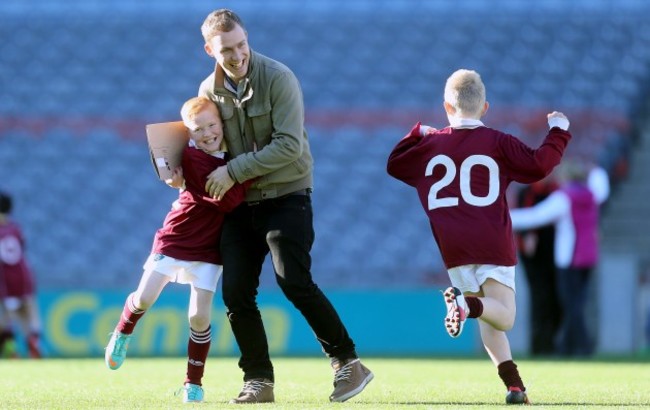 Quinn Berryman and Nathan Brophy celebrate with Teacher/Coach Ciaran Cronin at the final whistle