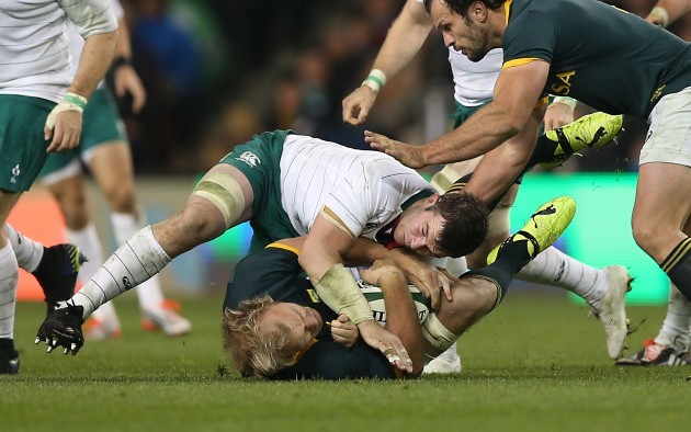 Schalk Burger is tackled by Peter O'Mahony