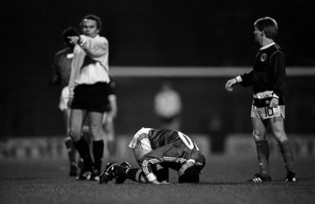 Gordon Strachan stands over an injured John Aldridge