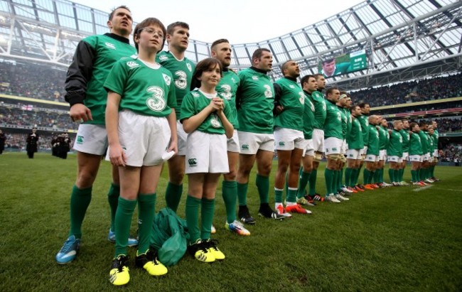 Eoin Reddan with the mascots and the Irish team stand for the national anthem