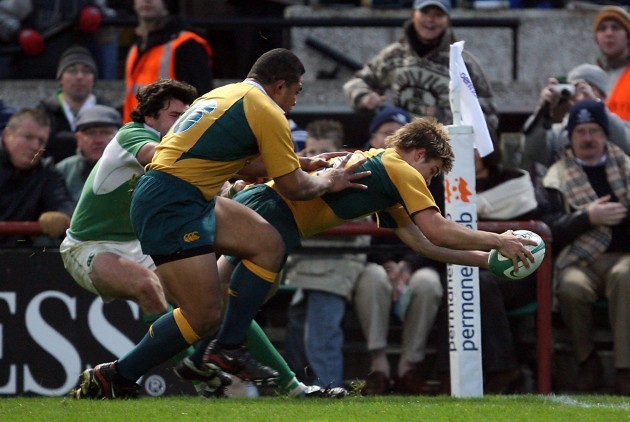 Drew Mitchell of Australia scores as Shane Horgan tries to stop him 19/11/2005