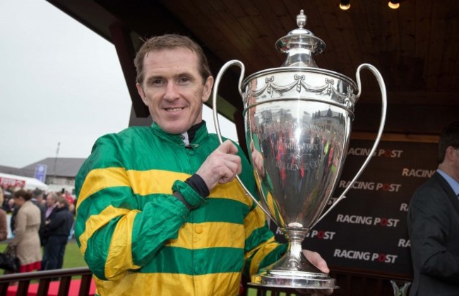 Tony McCoy celebrates with the trophy after winning