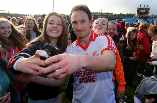 Alan Dillon celebrates with a fan by taking a 'selfie'