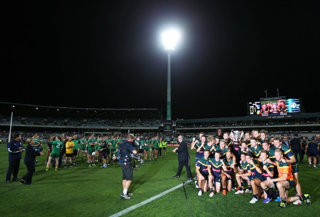 Australia players celebrate with the Cormac McAnallen Cup