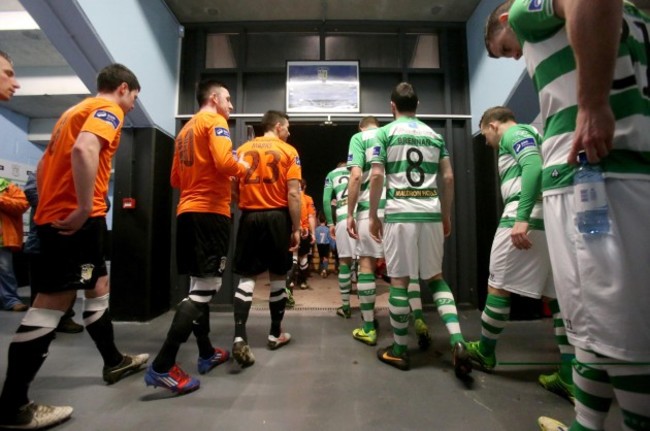 The two teams make their way out for the start of the game