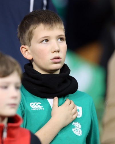 A young Ireland fan sings the national anthem