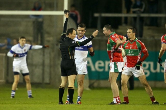 Ger Brennan is shown a black card by John Hickey