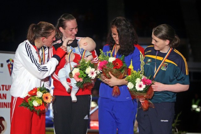 Clare Grace celebrates with her bronze medal on the podium