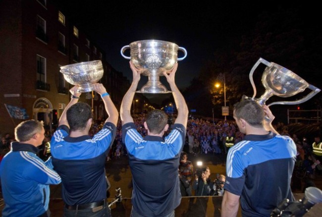 Dublin manager Jim Gavin,Rory O'Carroll, captain Stephen Cluxton and Denis Bastick show the Leinster Trophy, the league trophy and the Sam Maguire to the crowd.