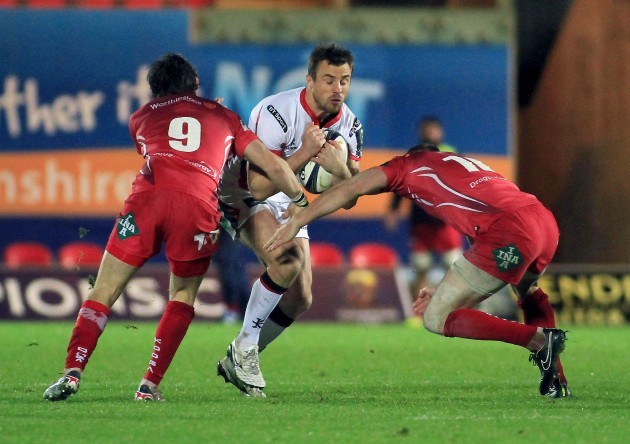 Tommy Bowe is tackled by Rhodri Williams and Rhys Priestland