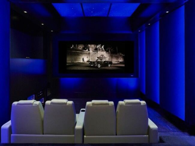 the-movie-theater-is-filled-with-comfortable-chairs-and-a-huge-screen