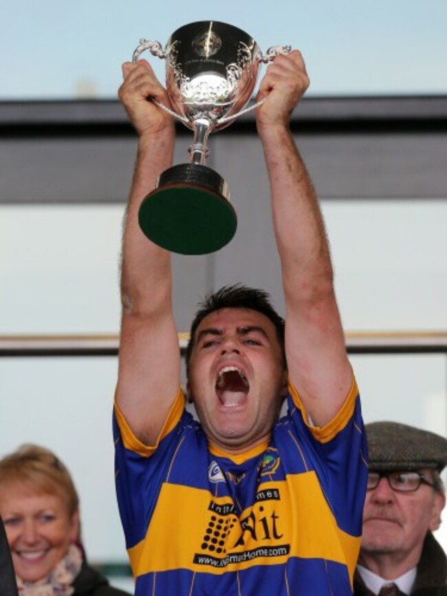 John Convery raises the Four Season Cup