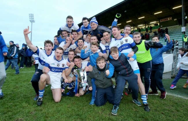 St Vincent's players celebrate with the trophy