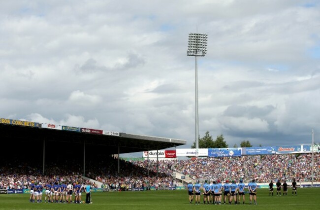 The teams stand for a minutes silence