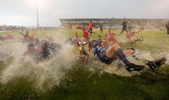 Sligo Rovers players celebrate on the rain soaked pitch at the end of the game