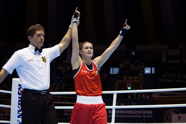 Katie Taylor has her arm raised by the referee after the judges declared her the winner