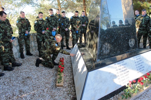 CS Mark Gallacher places a rose at Tibnine Monument in memory of fallen comrades