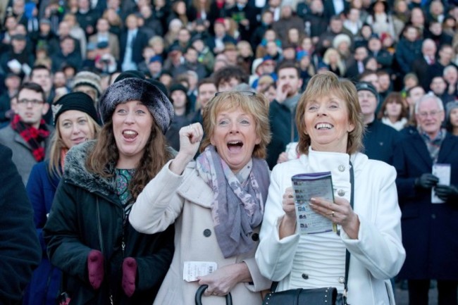 Racegoers cheer on the horses