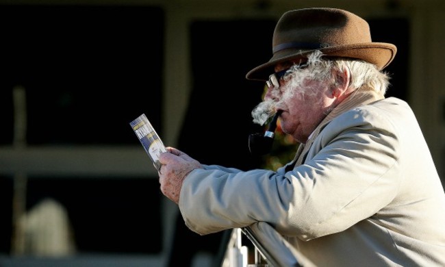 A racegoer check his race card