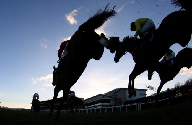 Riders and runners clear a fence