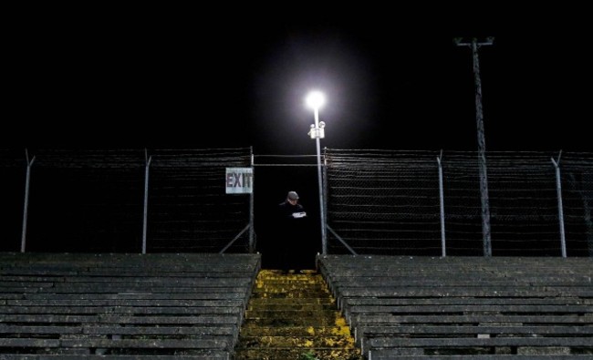 A spectator checks his program during the game