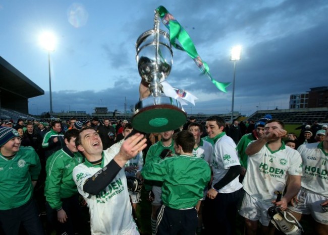 Paul Shefflin celebrates with the trophy after the game