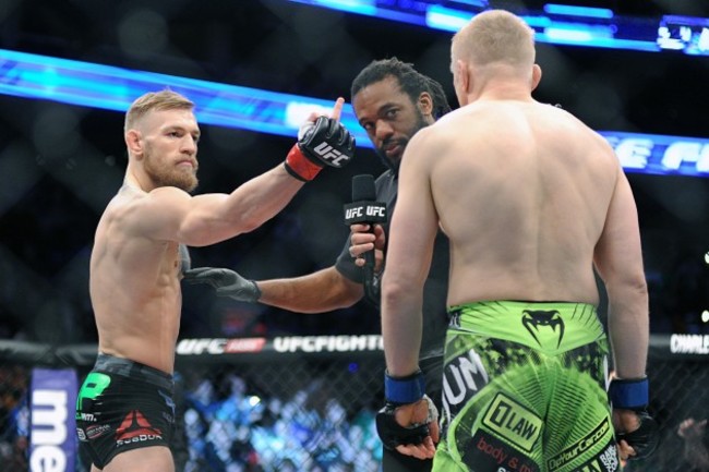 Referee Herb Dean talks to Conor McGregor and Denis Siver before the fight