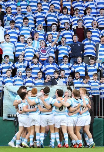 The Blackrock team form a huddle as their fans sing