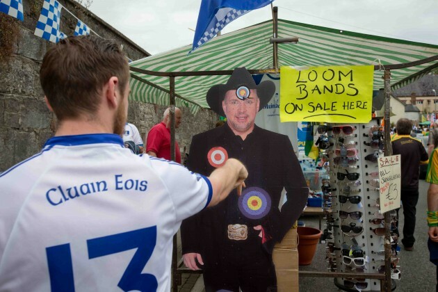 Ciaran Morgan from Clones throws darts at a cardboard cutout of Garth Brooks