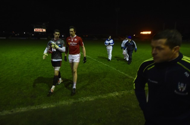 Niall Morgan and Colm Cavanagh leave the pitch after the lights went out