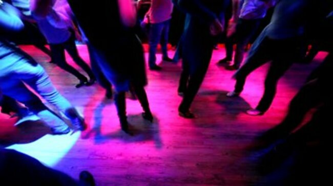 stock-footage-legs-of-many-dancing-men-and-women-in-some-nightclub-with-different-colors-blinking